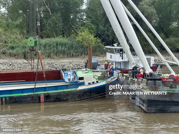 The scene of the salvaging works to bring the Dutch barge that sunk last week on the Schelde river to the surface, in Grembergen near Dendermonde, on...