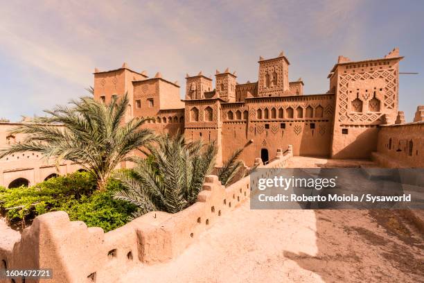 old kasbah and palm trees in a desert oasis - morocco stock pictures, royalty-free photos & images