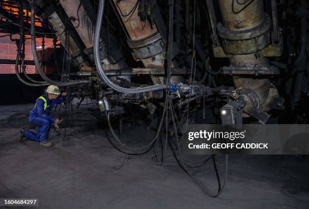 Tata Steel shift manager Stuart Phillips looks through a camera into the base of blast furnace number four at the Tata Steel Port Talbot integrated...