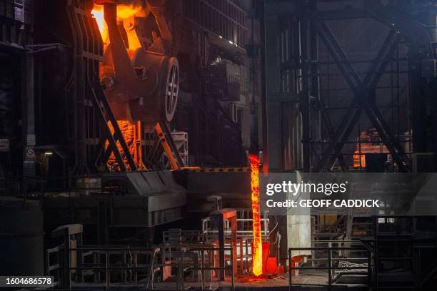 Ladle pours 280 tonnes of molten iron into the steel converter at the Tata Steel Port Talbot integrated iron and steel works in south Wales on 15...