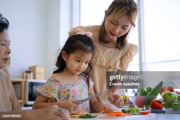 grandmother, mother and granddaughter prepare food in the kitchen. - girl making sandwich stock pictures, royalty-free photos & images