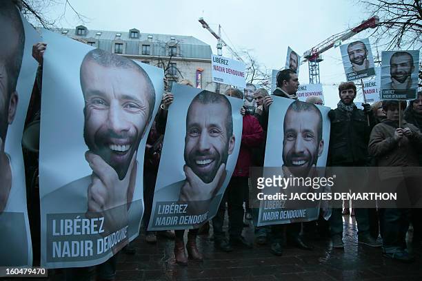 People take part in a demonstration to free French journalist Nadir Dendoune, arrested and detained in Iraq since January 23, in Paris on February 1,...