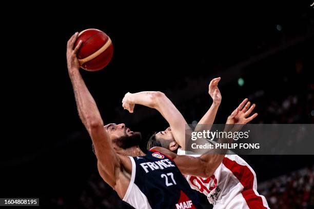 Japan's Koya Kawamata tries to block France's Rudy Gobert during the international basketball game between Japan and France at Ariake Arena in Tokyo...
