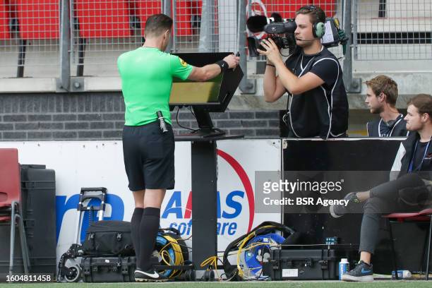 Referee Danny Makkelie watching the replay screen after consulting the VAR during the Dutch Eredivisie match between AZ and Go Ahead Eagles at AFAS...
