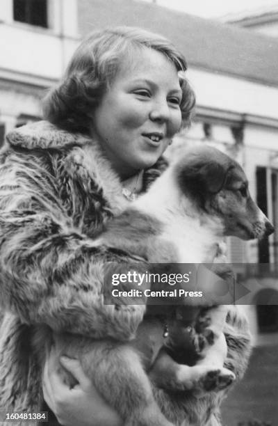 Princess Beatrix with a pet dog at Soestdijk Palace, Netherlands, on her thirteenth birthday, 31st January 1951.