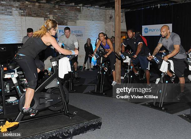 Trainer Holly Rilinger, former NFL player Troy Aikman, olympian Lolo Jones, NFL players Alfred Morris and Matt Forte attend The Flywheel Challenge at...