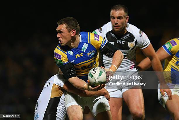 Kevin Sinfield of Leeds Rhinos is tackled by Daniel Holdsworth of Hull FC during the Stobart Super League match between Leeds Rhinos and Hull FC at...