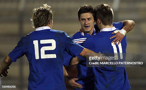 France's Vincent Mallet is congratulated by teammates during the 6 Nations Rugby Under 20 match against Italy at Tomaselli Stadium on February 1,...