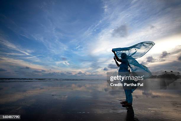 woman enjoying breeze,seabeach,mandarmani - 民族衣装 ストックフォトと画像