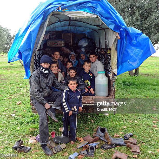 Outside the village of al Sahriah, north of Hama, Syria, a family of 10 fleeing the government's bombardment of their village brought their shelter...