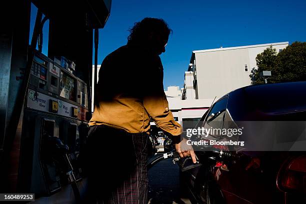 Customer fills a vehicle with gasoline at a Chevron Corp. Station in San Francisco, California, U.S., on Friday, Feb. 1, 2013. Chevron Corp., the...