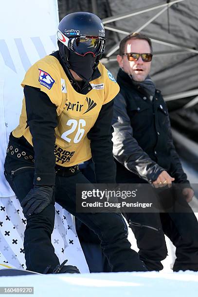 Shaun White of the USA prepares to take a practice run while his coach Bud Keene watcher as White went on to win the FIS Snowboard Halfpipe World Cup...