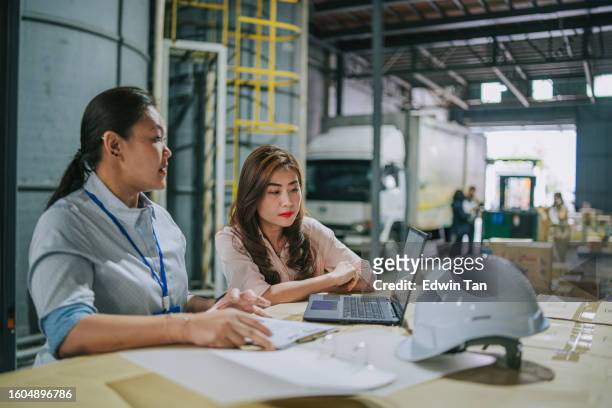 asian chinese female foreperson discussion with coworker in warehouse on logistic shipment planning - quality control stock pictures, royalty-free photos & images