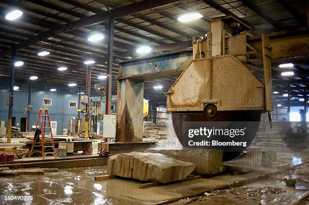 Large block saw blade cuts into a piece of sandstone at the Cleveland Quarries facility in Vermilion, Ohio, U.S., on Friday, Feb. 1, 2013. Spending...