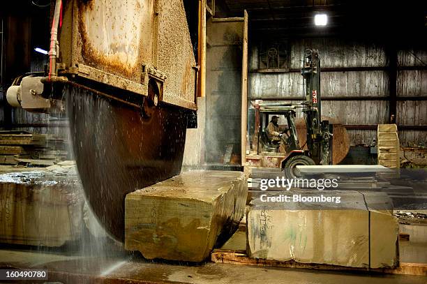 Large block saw blade cuts into a piece of sandstone at the Cleveland Quarries facility in Vermilion, Ohio, U.S., on Friday, Feb. 1, 2013. Spending...