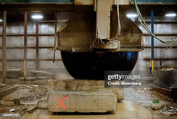 Large block saw blade cuts into a piece of sandstone at the Cleveland Quarries facility in Vermilion, Ohio, U.S., on Friday, Feb. 1, 2013. Spending...