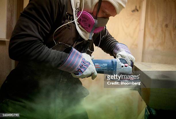 Worker makes a cut in the side of a sandstone block in the hand fabrication area of the Cleveland Quarries facility in Vermilion, Ohio, U.S., on...