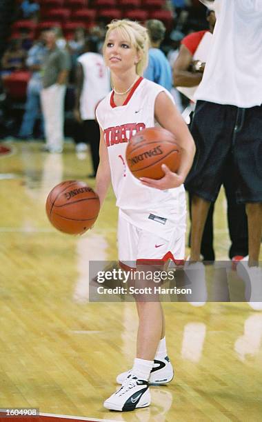 Pop singer Britney Spears dribbles a basketball during warmups for NSync''s "Challenge for the Children III" charity event July 29, 2001 at the...