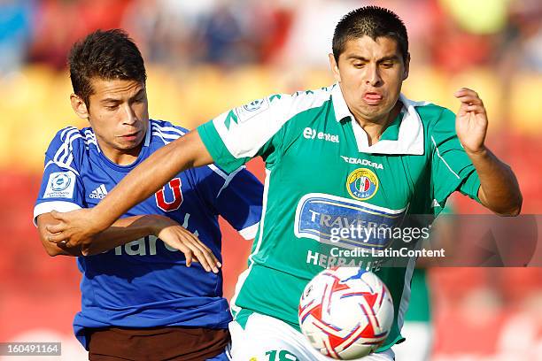 Michel Contreras of Universidad de Chile fights for the ball with Alexis Delgado of Audax Italiano during a match between Universidad de Chile and...