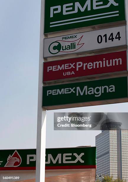 The Petroleos Mexicanos administrative building stands in the distance past one of the company's gas stations in Mexico City, Mexico, on Friday, Feb....