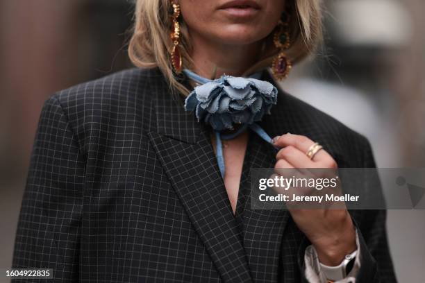 Karin Teigl seen wearing Munthe grey checked blazer jacket, gold pendant earrings, Zara light blue denim rose necklace, during the Copenhagen Fashion...