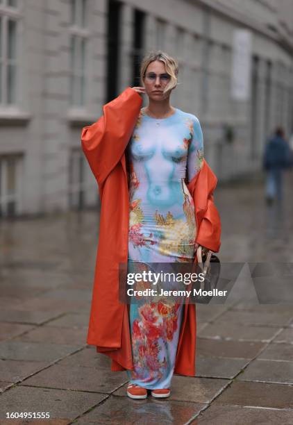 Karin Teigl seen wearing Jean Paul Gaultier light blue colorful print pattern long dress, Andy Wolf light blue transparent pilot sunglasses, NA-KD...