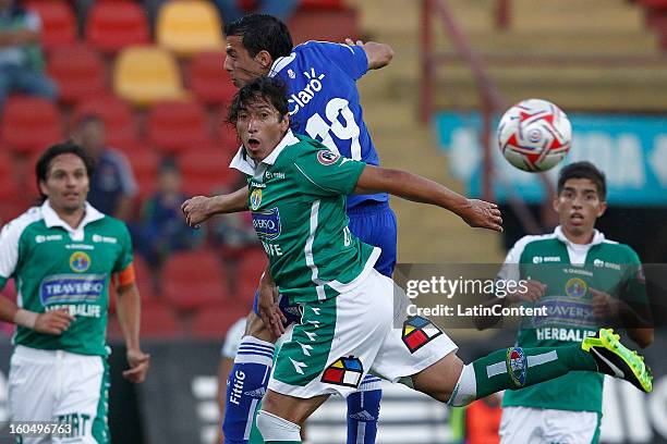 Sebastian Ubilla of Universidad de Chile fights for the ball with Cristian Oviedo of Audax Italiano during a match between Universidad de Chile and...