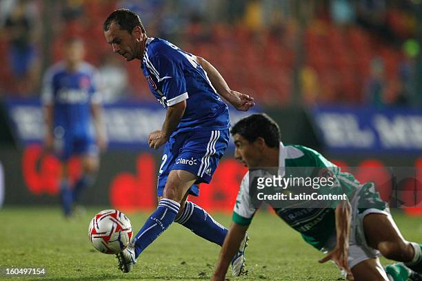 Gustavo Lorenzetti of Universidad de Chile fights for the ball with Ivan Vazquez of Audax Italiano during a match between Universidad de Chile and...