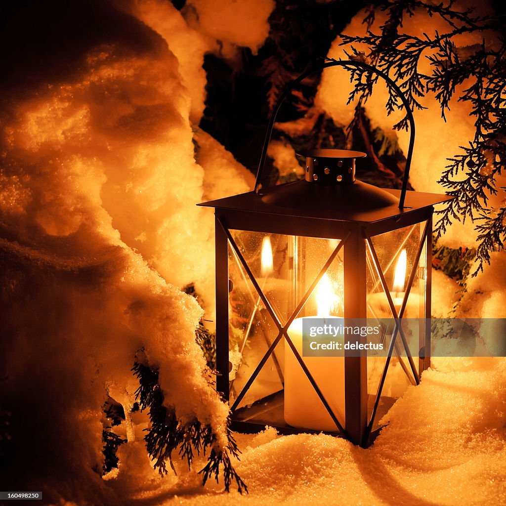Warm lantern light in the snow