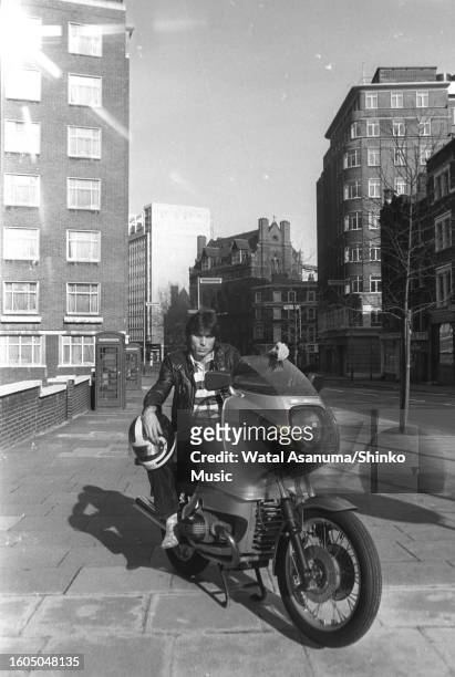Portrait of English Rock musician Cozy Powell as he poses on a motorbike near Central Studios during the recording his first solo album, London,...