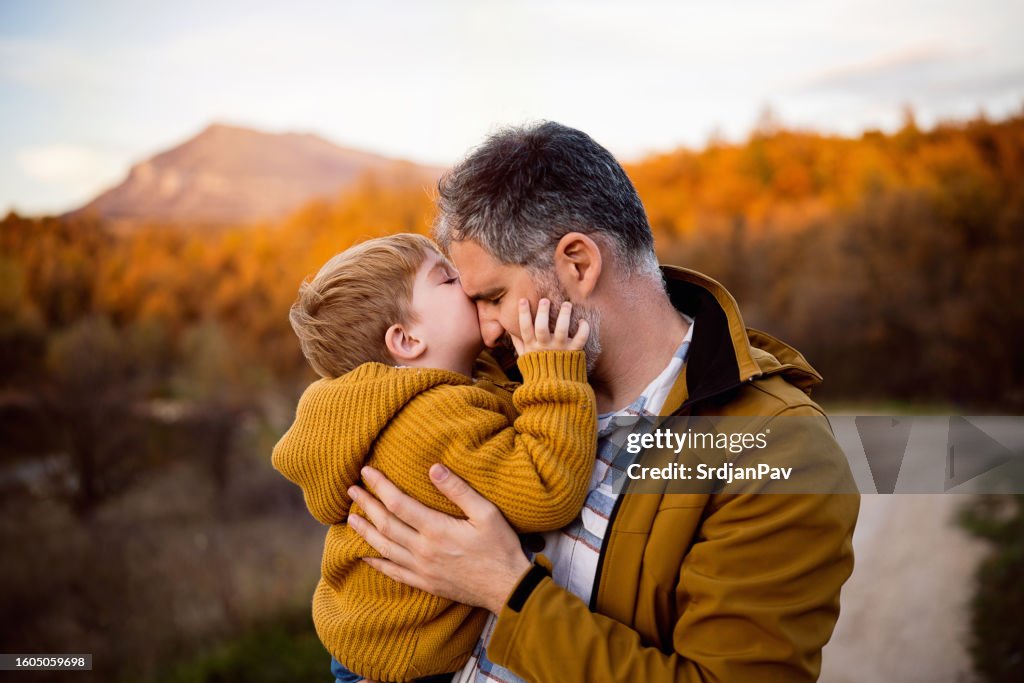 Father and son enjoying a carefree autumn day in nature