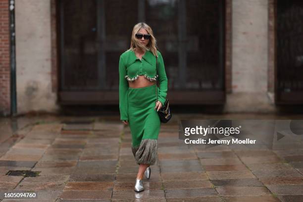 Karin Teigl seen wearing Louis Vuitton black sunglasses, Milk White green two-piece / green cropped collar knit cardigan with long sleeves and shell...