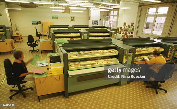 Employees work in the facility where the former East German intelligence agency''s files are housed, July 18, 2001 in Berlin. The intelligence agency...