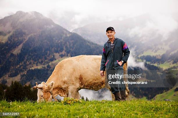 swiss dairy farmer and his prize cow - swiss cow stock pictures, royalty-free photos & images