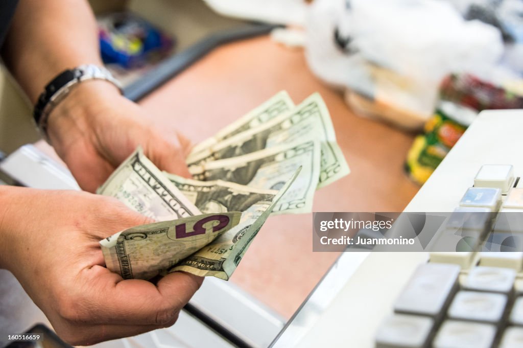 Store cashier counting the cash