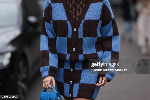 Lina Uhrig seen wearing Gestuz brown / black triangle print pattern blouse, Stine Goya brown / blue checked knit wool cardigan, matching Stine Goya...