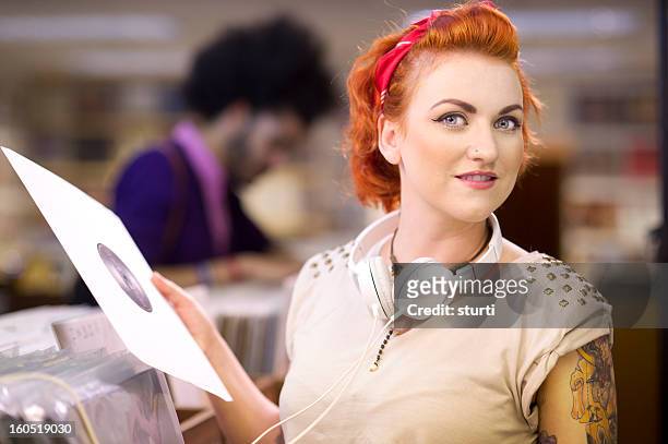 young woman in a record shop - 45 rpm stock pictures, royalty-free photos & images