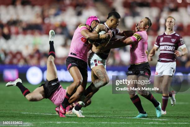 Haumole Olakau'atu of the Sea Eagles is tackled during the round 24 NRL match between Manly Sea Eagles and Penrith Panthers at 4 Pines Park on August...