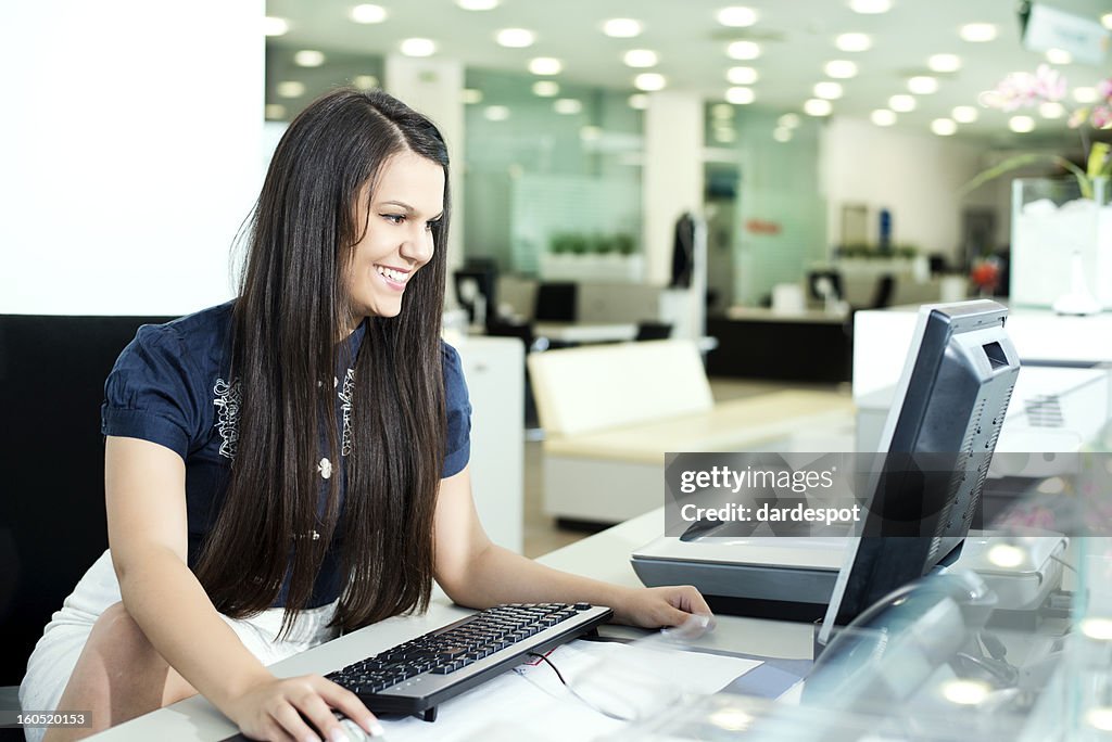 Smiling businesswoman working on her computer