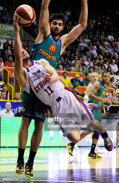 Aaron Bruce of the Kings dives to make a basket past Todd Blanchfield of the Crocodiles during the round 17 NBL match between the Townsville...
