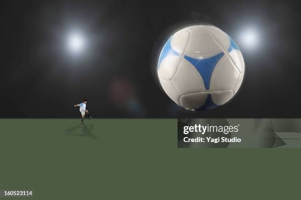 man kicking a soccer ball - giant night of comedy stock-fotos und bilder