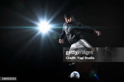 Man kicking a soccer ball Man kicking a soccer ball