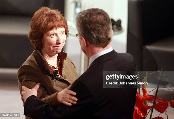 Thomas de Maiziere , German minister of defense, welcomes Catherine Ashton, vice president of the European commission, during day 2 of the 49th...