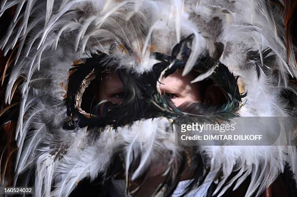 Boy looks on through his mask during the International Festival of the Masquerade Games in Pernik near Sofia, on February 2, 2013. The three-day...