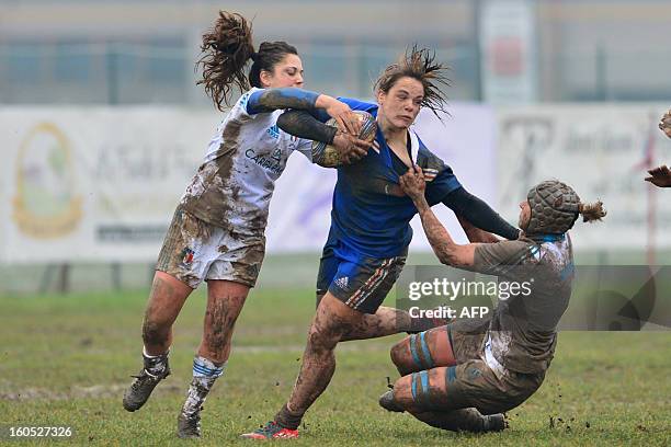 France's Elodie Poublan vies with Italian's Lucia Gai and Silvia Gaudino during the Six Nations women Rugby Union match between Italy and France on...