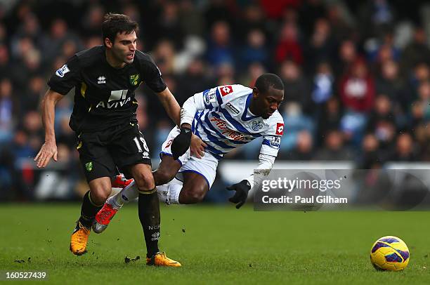 Shaun Wright-Phillips of Queens Park Rangers battles for the ball with Javier Garrido of Norwich City during the Barclays Premier League match...