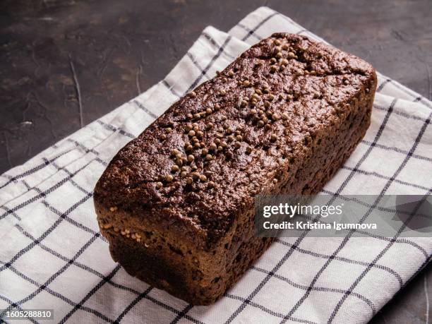 fresh rye black bread. top view. black stone background, rustic style. - close up bread roll black backdrop horizontal stock pictures, royalty-free photos & images