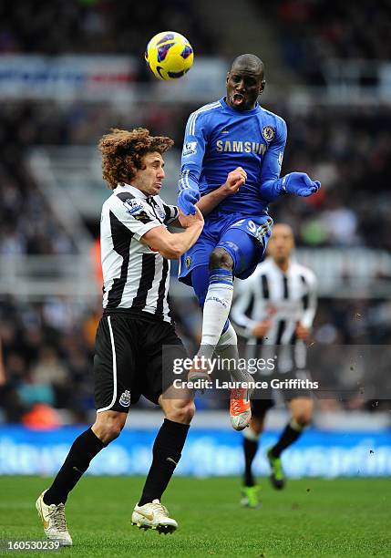 Demba Ba of Chelsea battles with Fabricio Coloccini of Newcastle United during the Barclays Premier League match between Newcastle United and Chelsea...