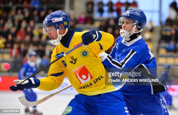 Sweden's Patrik Nilsson and Finland's Samuli Helavuori vie during Bandy World Championship semifinal match Sweden vs Finland in Vanersborg, Sweden,...