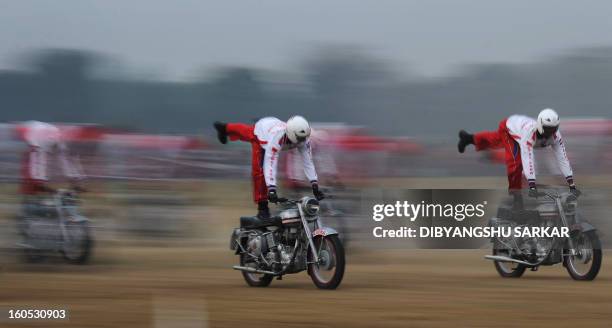 Indian Army daredevil motorcyle team members displays their skills during an Army weaponry exhibition in Kolkata on February 2, 2013. The event was...